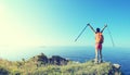 Cheering young woman hiker open arms on seaside mountain Royalty Free Stock Photo