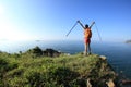 Cheering young woman hiker open arms on seaside mountain Royalty Free Stock Photo