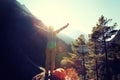 Cheering young woman hiker open arms to the sunrise Royalty Free Stock Photo