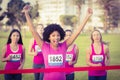 Cheering young woman winning breast cancer marathon Royalty Free Stock Photo