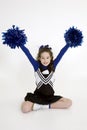 Nine year old Caucasian girl dressed in a blue cheerleader outfit Royalty Free Stock Photo