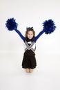Nine year old Caucasian girl dressed in a blue cheerleader outfit Royalty Free Stock Photo