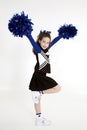 Nine year old Caucasian girl dressed in a blue cheerleader outfit