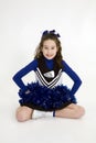 Nine year old Caucasian girl dressed in a blue cheerleader outfit Royalty Free Stock Photo