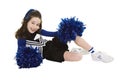 Nine year old Caucasian girl dressed in a blue cheerleader outfit