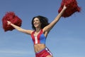 Cheerleader Cheering With Arms Raised While Holding Pompom