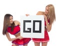 Cheerleader dancer girls from cheerleading team hold sign