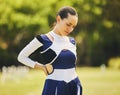 Cheerleader, fitness injury and back pain from sport, training and cheer exercise on a grass field. Health, accident and