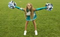 Cheerleader girl with poms on field Royalty Free Stock Photo