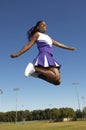 Cheerleader jumping on field Royalty Free Stock Photo