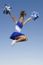 Cheerleader Jumping With Pom-Poms