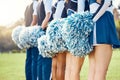 Cheerleader pom poms, backs and students in cheerleading uniform on a outdoor field. Athlete group, college sport Royalty Free Stock Photo