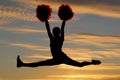 Cheerleader silhouette leaping in air doing the sp