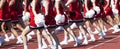 Cheerleaders cheering on the sidlines during a high school football game