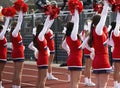 Cheerleaders cheering to the stands at a football game Royalty Free Stock Photo