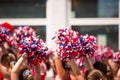 Cheerleaders Waving Red, White, and Blue Pom Poms During Fourth of July Parade Royalty Free Stock Photo