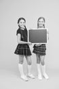 Cheerleading classes. School girls cute pupils red uniform hold blackboard copy space. School announcement concept Royalty Free Stock Photo