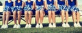 Cheerleading Squad Sitting on Bench Royalty Free Stock Photo