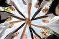 Cheerleading team holding hands outdoors