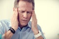 Cheerless moody man holding his temples Royalty Free Stock Photo