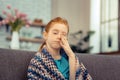 Cheerless pale young girl rubbing her face Royalty Free Stock Photo