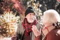 Cheerless sad man having an argument with his wife