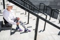 Cheerless senior woman resting after climbing up stadium ladder outdoor Royalty Free Stock Photo