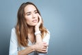 Cheerless thoughtful woman holding her cheek