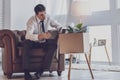 Cheerless unhappy man sitting at home