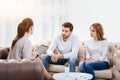 Cheerless young couple visiting a psychologist