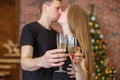 Cheers! Close up photo of two people holding glasses of shampagne on Christmas Royalty Free Stock Photo