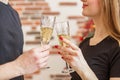 Cheers! Close up photo of two people holding glasses of shampagne on Christmas