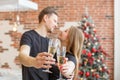 Cheers! Two people holding glasses of shampagne on Christmas. Couple celebrate New Year together Royalty Free Stock Photo