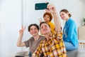 Cheers Funky mood. Happy group of friends make selfie. Man taking photo of friends at party. Group of multiracial young Royalty Free Stock Photo