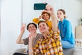Cheers Funky mood. Happy group of friends make selfie. Man taking photo of friends at party. Group of multiracial young Royalty Free Stock Photo