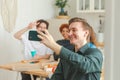 Cheers Funky mood. Happy group of friends make selfie. Man taking photo of friends at party. Group of multiracial young Royalty Free Stock Photo