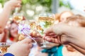 Cheers. Group of people drinking and toasting in restaurant. Hands holding glasses of champagne and wine making toast Royalty Free Stock Photo