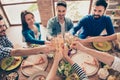 Cheers! High angle view of friends at birthday party clinking glasses with champagne and toasting, tasty dishes on the table Royalty Free Stock Photo