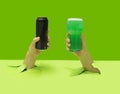 Cheers minimal party concept. Two mans hands holding black can of beer and pint of green alcohol pops out from pastel green floor