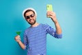 Cheers. Photo of funky traveler guy taking blog telephone selfies drink green cocktail all inclusive resort wear sun