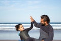 Cheery father with mechanical leg with daughter on beach Royalty Free Stock Photo