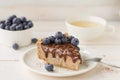 Cheescake with chocolate sauce and blueberries with tea Royalty Free Stock Photo