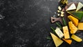 Cheese. Assortment of cheese and snacks on black stone background. Top view. Royalty Free Stock Photo