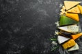 Cheese. Assortment of cheese and snacks on black stone background. Top view. Royalty Free Stock Photo