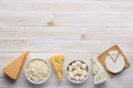 Cheese assortment on white wooden table top view