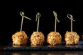 Cheese balls in breading, with natural bamboo skewers. Royalty Free Stock Photo