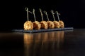 Cheese balls in breading, with natural bamboo skewers. Royalty Free Stock Photo