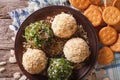 Cheese balls with crackers, herbs and seeds close-up. horizontal