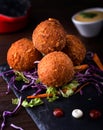 Cheese Balls with dip, onion, carrot and lettuce leaf served in dish isolated on wooden table side view of arabic food Royalty Free Stock Photo