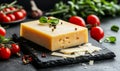 Cheese on black board with spices on rustic background Royalty Free Stock Photo